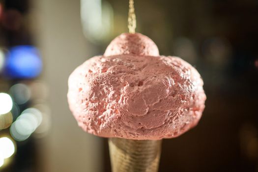 Icecream cone artificial hanging on display of cafe store Venchi in Milan, Italy. Ice cream cone decorative background.