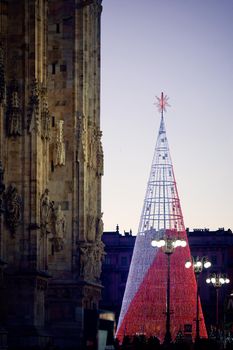 Christmas tree in front of Milan cathedral, Duomo square in december, night view. Decorated tree in european downtown. Christmas in Europe. Milan, Italy - December, 25, 2019