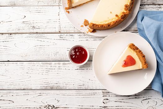 Tasty homemade cheesecake on white wooden table with copy space