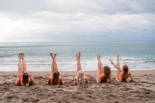 Big happy family or group of five friends is having fun against sunset beach. Beach holidays concept