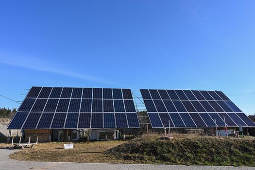 High resolution front view of solar panels against a clear blue sky