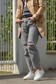 Woman in jeans and autumn coat.