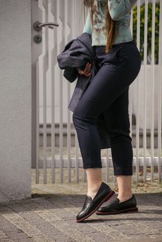 Female fashion concept. Outdoor portrait of a young beautiful woman posing on the street. Model wearing stylish clothes. City lifestyle