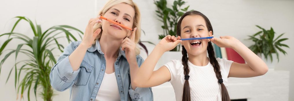 A mother helping her daughter with homework.