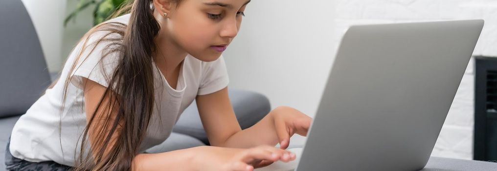 little girl studying with computer, little girl with laptop online