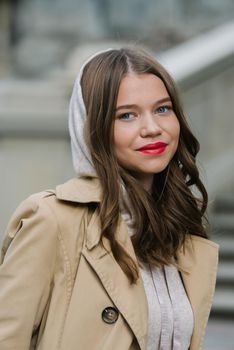 Portrait of fashionable women in beige sports suit and trench coat posing. street look fashion