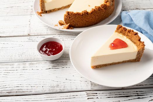 Tasty homemade cheesecake on white wooden table with copy space