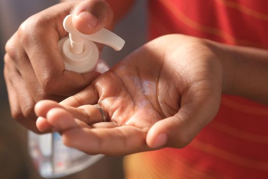 close up of young man hand using sanitizer gel for preventing virus.