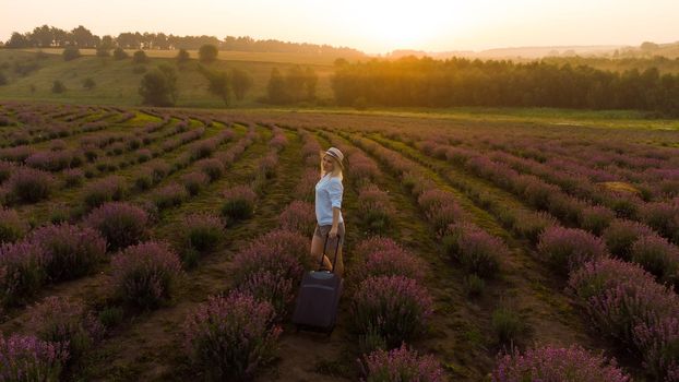 women with a suitcase and lavender field