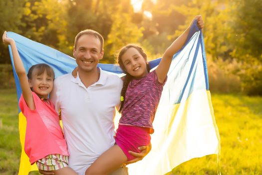 Ukraine's Independence Flag Day. Constitution day. family with the flag of ukraine in field. 24 August. Patriotic holiday