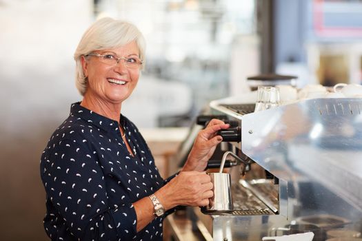 Portrait of a senior woman working in a coffee shop.