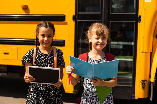 Lucky to meet each other. Cheerful smart schoolgirls. Happy schoolgirls outdoors. Small schoolgirls wear school uniform. Cute schoolgirls looking charming. Ending of school year