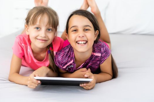 Little girls using tablet computer as art board - painting together.