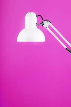 Office table lamp on pink background with space for text and idea concept