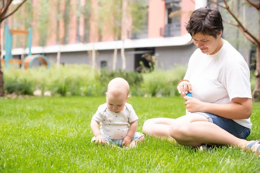 Mother and baby in park portrait.