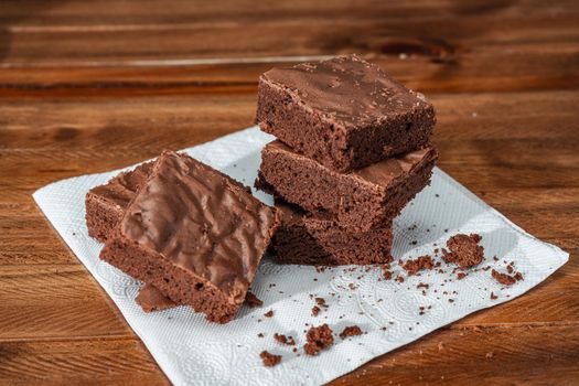 Homemade chocolate brownie squares on a table. High view.