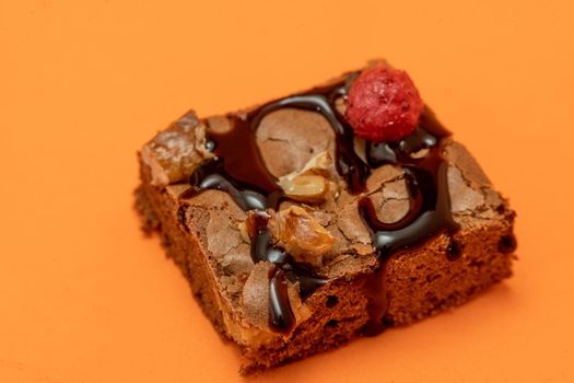 Chocolate brownie squares with walnut pieces, chocolate threads and granola. Natural, healthy food concept. High view. Copy space.