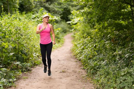 Running woman. Female Runner Jogging during Outdoor Workout in a Park. Beautiful fit Girl. Weight Loss