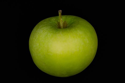 Fresh green apple and sliced isolated on black background art abstract concept.