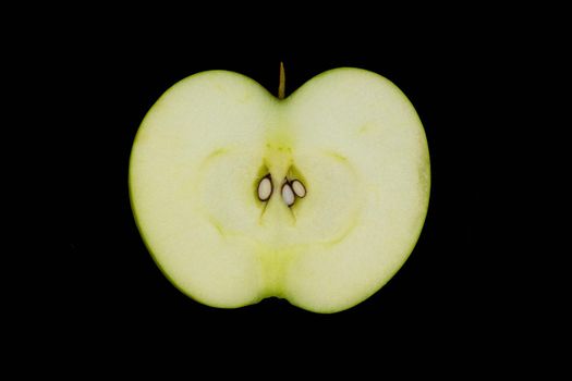 Fresh green apple and sliced isolated on black background art abstract concept.