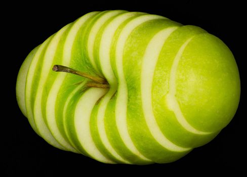 Fresh green apple and sliced isolated on black background art abstract concept.