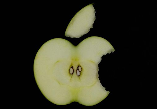 Fresh green apple and sliced isolated on black background art abstract concept.