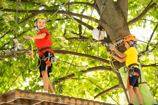 Boy climber walks on the rope bridge