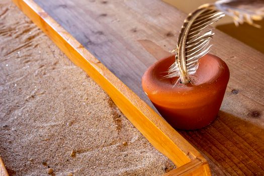 desk with sand and feather in an old school