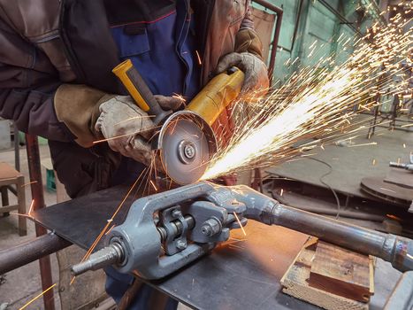 Grinding Work with Smooths Equipment for Steel Metal, Iron, Sparks at Manufacturing Heavy Industry Factory Close Up Indoor.