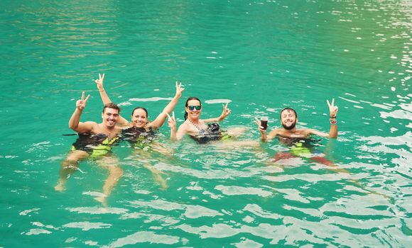 High angle portrait of a group of young friends swimming in a lake.