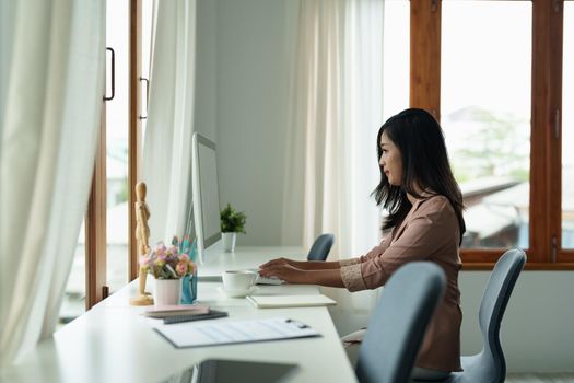 Freelance or student asian woman using pc computer for online education or work from home