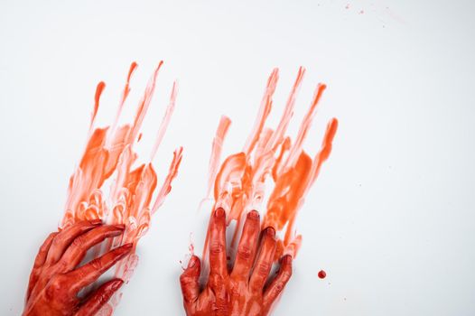 Female hands in blood on a white background