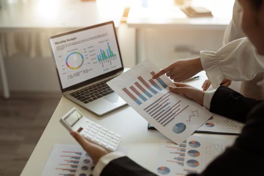 Business people adviser analyzing investment graph meeting brainstorming and discussing plan in meeting room, investment concept.