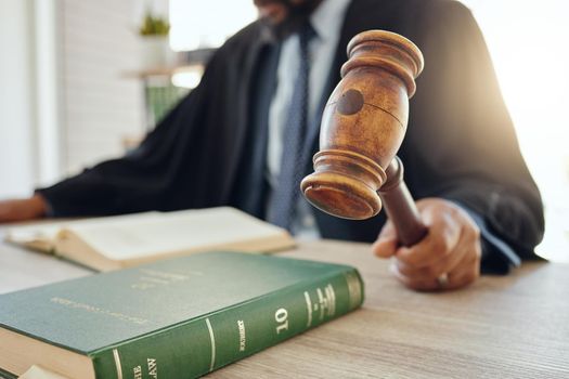 Shot of an unrecognizable lawyer using a gavel at work.