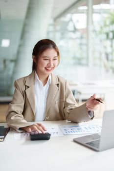 Data analysis, roadmap, marketing, accounting, auditing. Portrait of Asian businesswoman using computer in video conferencing, presenting marketing plan using statistical data sheet at work