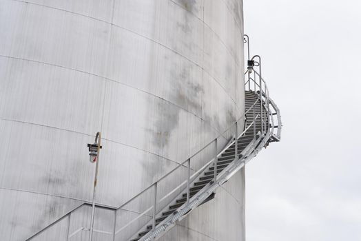 Iron staircase for up to maintenance work. Steel stairs are on the side of the building walls.