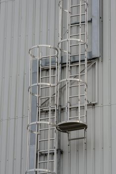 Iron staircase for up to maintenance work. Steel stairs are on the side of the building walls.