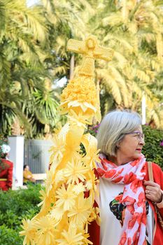 Elche, Alicante, Spain- April 10, 2022: People with white palms for the Palm Sunday of the Holy Week of Elche