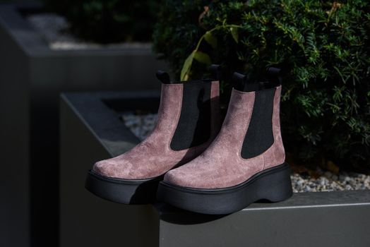 Rose trendy boots. fashion female shoes still life.