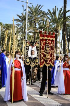 Elche, Alicante, Spain- April 10, 2022: People with white palms for the Palm Sunday of the Holy Week of Elche