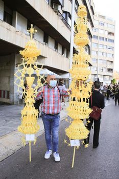 Elche, Alicante, Spain- April 10, 2022: People with white palms for the Palm Sunday of the Holy Week of Elche