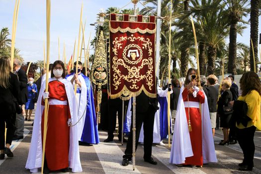 Elche, Alicante, Spain- April 10, 2022: People with white palms for the Palm Sunday of the Holy Week of Elche