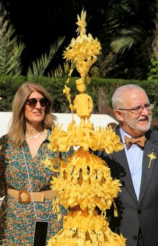 Elche, Alicante, Spain- April 10, 2022: People with award winning white palms for the Palm Sunday of the Holy Week of Elche