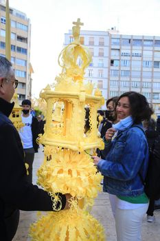 Elche, Alicante, Spain- April 10, 2022: People with white palms for the Palm Sunday of the Holy Week of Elche