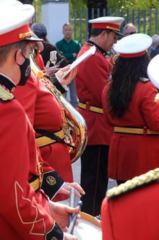 Elche, Alicante, Spain- April 10, 2022: Musicians in red uniform waiting for going out in procession in The Holy Week of Elche