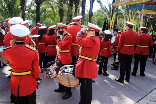 Elche, Alicante, Spain- April 10, 2022: Musicians in red uniform waiting for going out in procession in The Holy Week of Elche