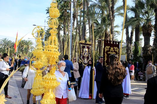 Elche, Alicante, Spain- April 10, 2022: People with white palms for the Palm Sunday of the Holy Week of Elche