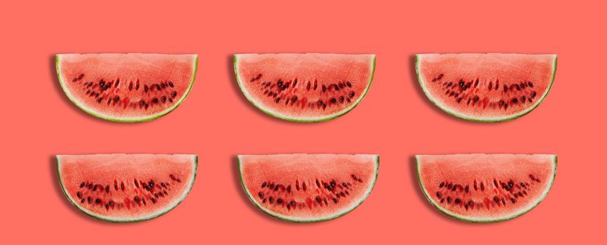 Six slices of a palatable watermelon in a cross-section on pink background with copy space for text or images. Special kind of a berry. Sweet juicy red flesh with black seeds. Side view. Close-up shot.