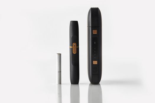 New generation black electronic cigarette, battery and one heatstick isolated on white. Hi-tech heating tobacco system. Tools used to help stop smoking. Advertising, close up, copy space, side view