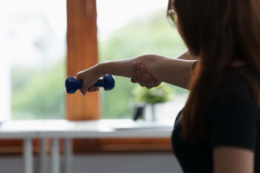 Woman doing the Rehabilitation therapy pain in clinic. Doctor or Physiotherapist. Doctor or Physiotherapist examining treating injured arm and shoulder